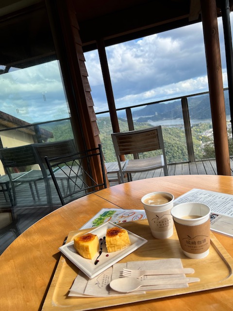 "Baum Brulee" and coffee on top of the ropeway. Notice the ocean in te distance! 